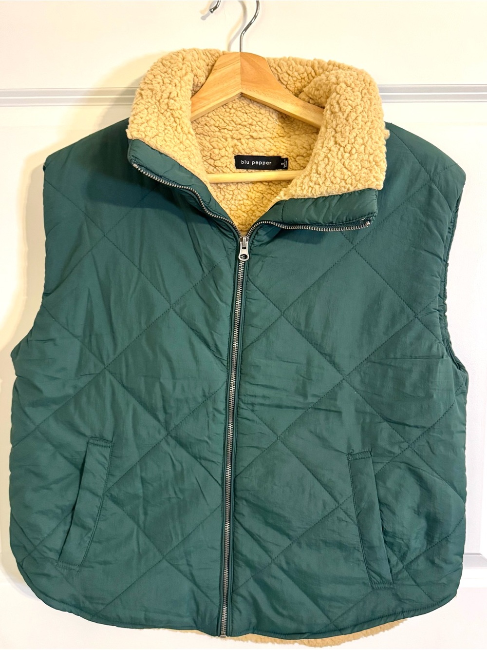 Blu Pepper quilted puffer vest in hunter green with tan sherpa lining.